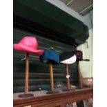 Four vintage ladies hats and stands.