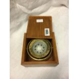 Brass ship's compass in a box.