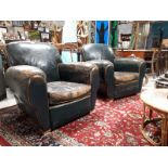 Pair of 1940's green leather upholstered club chairs.