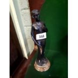 Art Deco painted spelter figure of a lady mounted on a marble base.