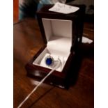 Sterling silver ladies dress ring set with blue stone.