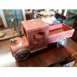 Painted tin model of a vintage truck.