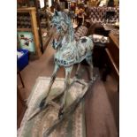 Large painted wooden rocking horse.