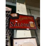 Wooden GAMBLING SALOON sign.