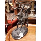 Bronze horse and rider on marble base.