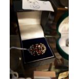 Sterling silver ladies dress ring set with garnets.