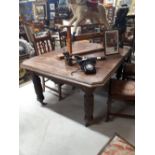 Edwardian oak dining room table on reeded legs.