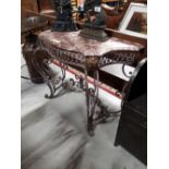 Decorative metal console table with marble top.