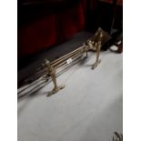 Set of brass fire dogs and irons.