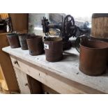 Set of five copper jugs.