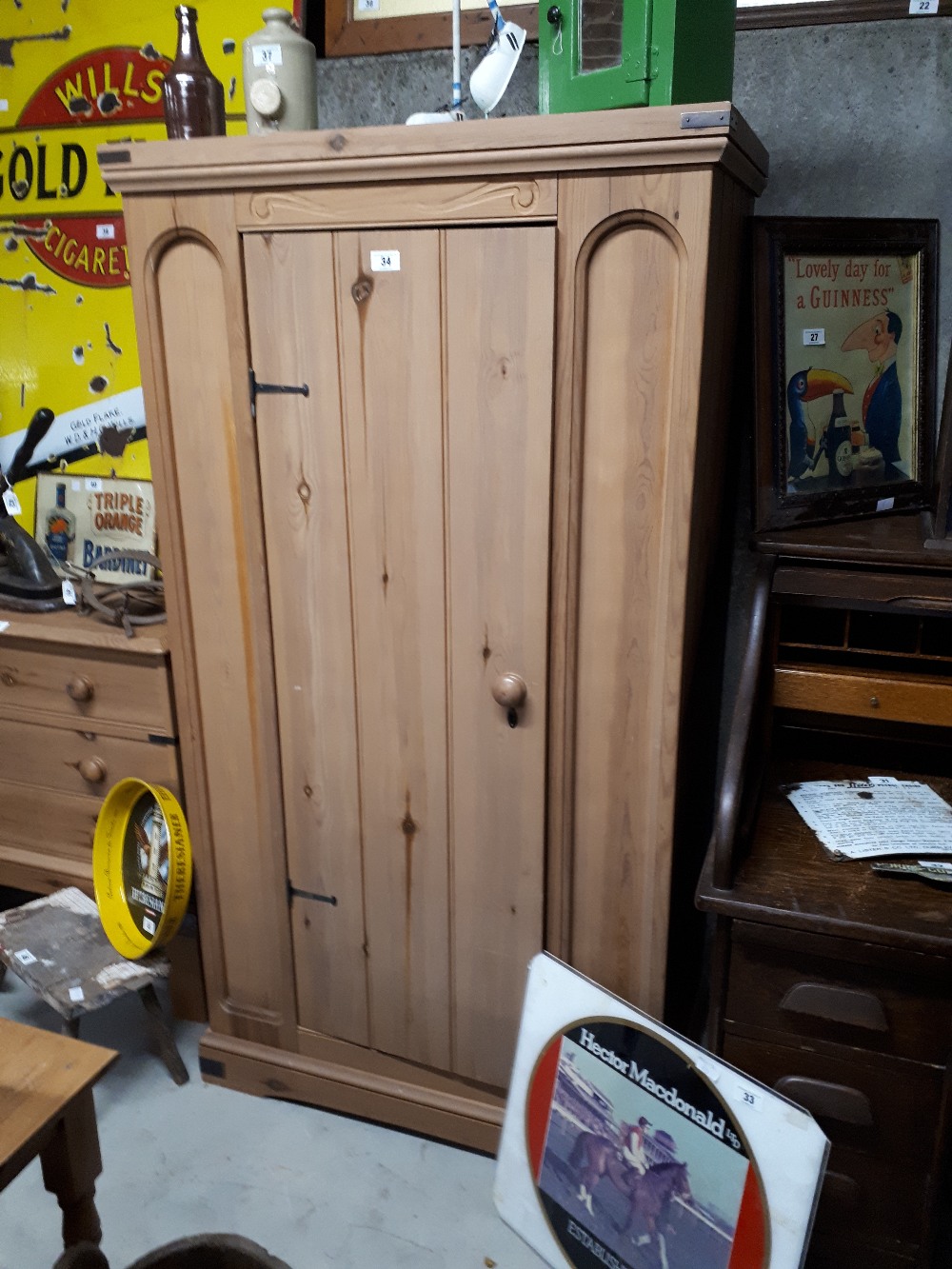 Stripped pine single door wardrobe.