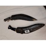 Two Gurkha kukri knives with scabbards.