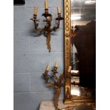 Set of four gilded brass wall lights with ensconces.