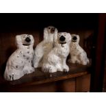 Four 19th. C. hand painted models of dogs.