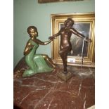 Two painted spelter figurines in the form of a dancer and lady knelling.