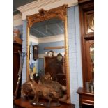 Decorative gilded wood mirror with bevelled edge plate.