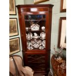 Edwardian inlaid mahogany corner cupboard with astragal glazed door above a panelled door.