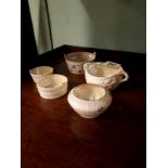 Four 3rd Period Belleek tubs and a 2nd Period Belleek bowl.