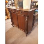 Regency mahogany side cabinet of neat proportions two draws over two doors flanked by half spiral