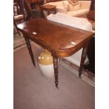 Georgian mahogany card table raised on turned legs.