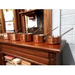 Set of five copper saucepans.