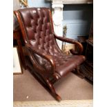 Leather upholstered mahogany button backed rocking chair.