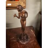 Bronze figurine mounted on a marble base in the Art Deco style.