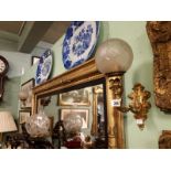 Pair of early 20th. C. gilded brass wall ensconces with football glass shades.