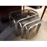 Nest of 1970's stainless steel and glass coffee tables.