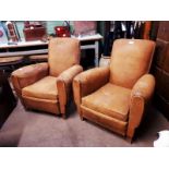 Pair of 1940s leather upholstered club chairs.