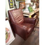 1960's ox blood red leather upholstered armchair.