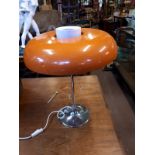 Rare mid-century chrome table lamp with orange glass shade.