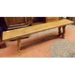 20TH CENTURY ELM BENCH WITH FRET CARVED ENDS AND WROUGHT IRON STRETCHER