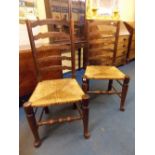 PAIR OF 19TH CENTURY NORTH DERBYSHIRE OAK/ELM WAVY LADDERBACK CHAIRS WITH RUSH SEATS