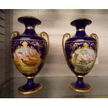 PAIR OF CAULDON BONE CHINA BLEU DE ROI AND GILDED OVOID TWIN HANDLED VASES PAINTED WITH PANELS OF