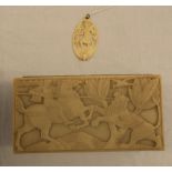 ART DECO PLASTIC CIGARETTE BOX DEPICTING ST GEORGE SLAYING THE DRAGON AND A CARVED BONE PENDANT