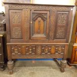 17TH CENTURY AND LATER OAK CARVED CUPBOARD ON STAND