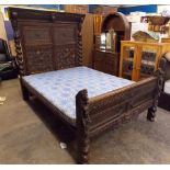ANTIQUE OAK CARVED AND GEOMETRIC MOULDED PANELLED BEDSTEAD WITH BARLEY TWIST COLUMNS,