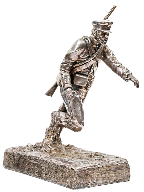 A heavy cast pewter figure of a Crimean War artilleryman, running forward through the mud, wearing