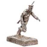 A heavy cast pewter figure of a Crimean War artilleryman, running forward through the mud, wearing