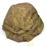 A reversible camouflage cloth cover for a Third Reich steel helmet, with loops for foliage and steel