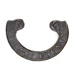 An Irish Militia brass scroll badge, for 1858 round forage cap, of the King’s County R Rifles (