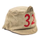 A WWI German grey linen foul weather shako cover, large red linen numerals “32” to the front,