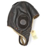 A WWII German sheepskin lined leather flying helmet, the lining with Siemens “Fl Kopfhaube” label.