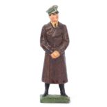 An Elastolin figure of Adolf Hitler. Standing in brown winter great coat with fixed arms. VGC, minor
