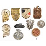 6 Third Reich pin back badges, of pressed tin or aluminium (pins missing); a small bronzed tank