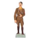 An Elastolin figure of Adolf Hitler. Standing in brown uniform with moveable arm. VGC, minor wear.