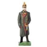 A Lineol figure of Field Marshall Hindenburg. Standing in grey winter greatcoat with pickelhaube and