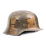 A Third Reich M42 steel helmet, the skull with added camouflage paint scheme and mostly