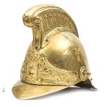 A French fireman’s brass helmet c 1900, brass binding to front and back peaks, studs at back, ear to